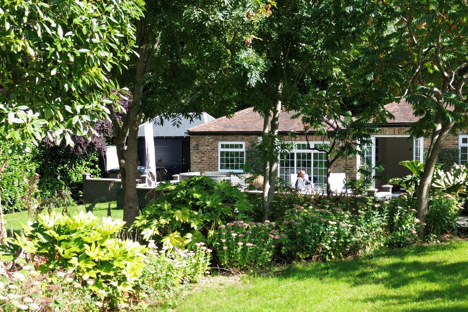 Gardens and loungers at Elysium Grove women’s retreat and wellness centre in Theobalds Park, Hertfordshire